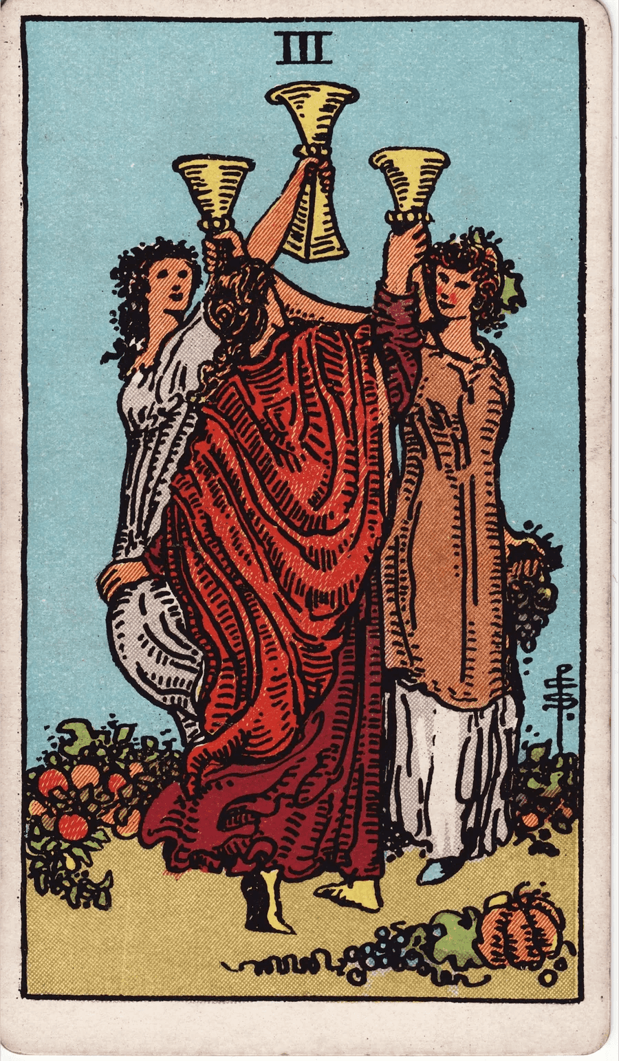 The Three of Cups from the 1909 Rider-Waite-Smith deck: three young women in flowing dresses raise their cups together in a garden, with fruit and pumpkins on the ground around them