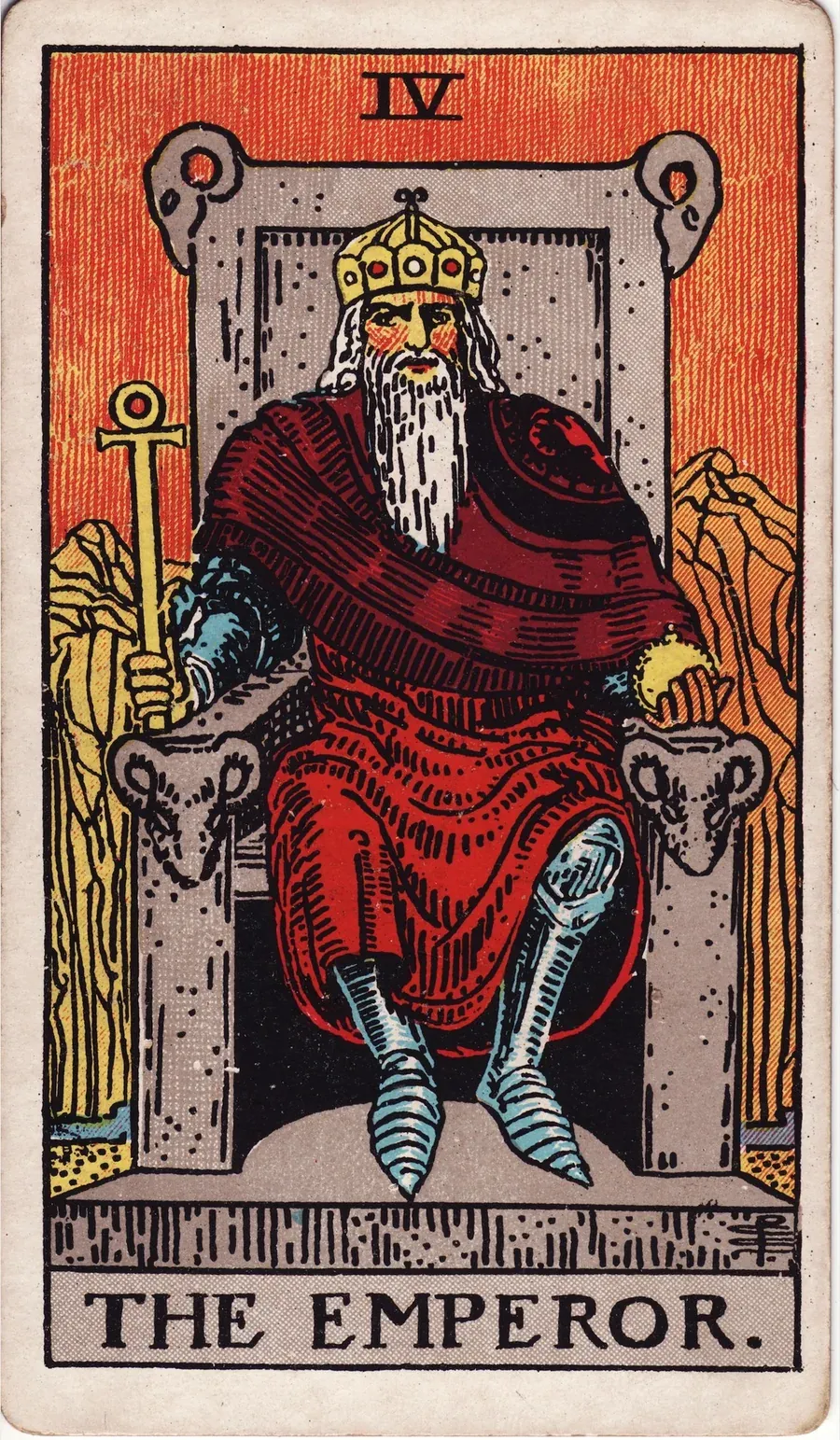 A bearded ruler in red robes over armor sits on a stone throne carved with rams’ heads, holding an ankh scepter and an orb, with bare mountains behind