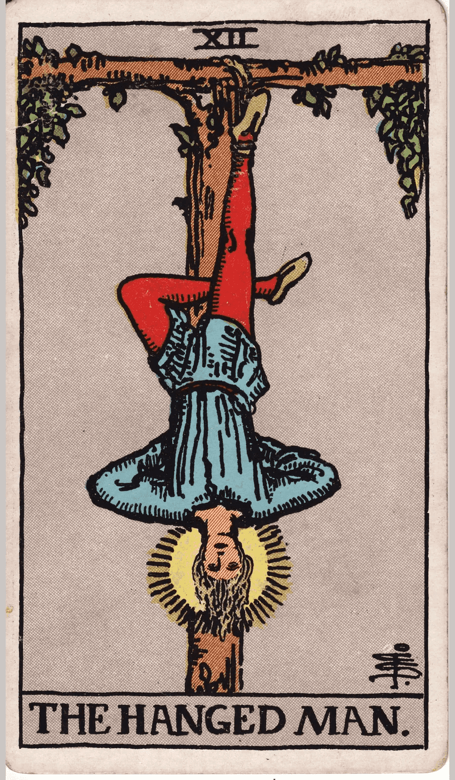 The Hanged Man card from the 1909 Rider-Waite-Smith deck: a man hangs upside down by one foot from a living T-shaped tree, his other leg bent behind him and a halo of light around his calm face