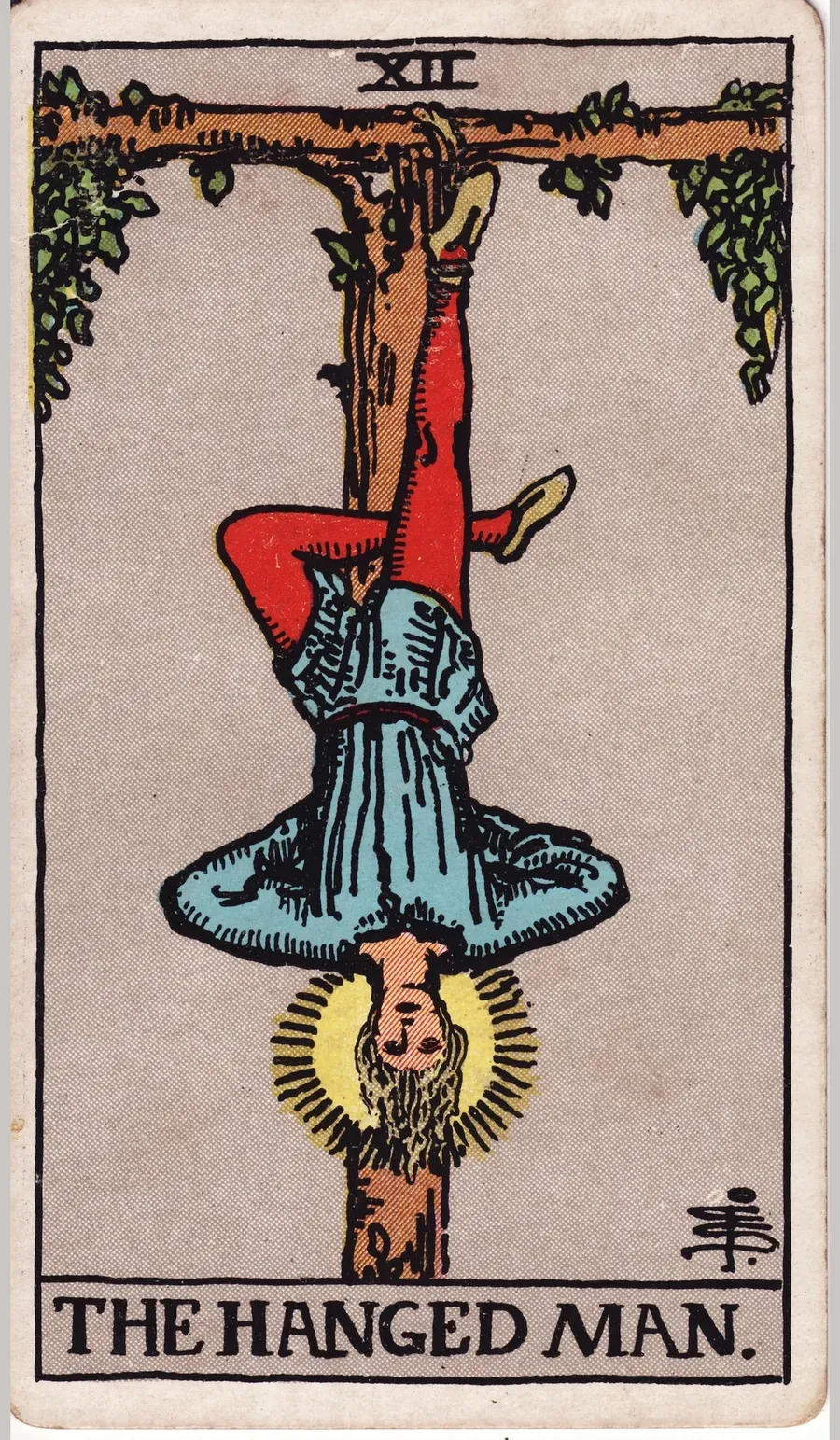 A man hangs upside down by one foot from a living wooden cross, his other leg bent behind, his hands behind his back, his head ringed with light