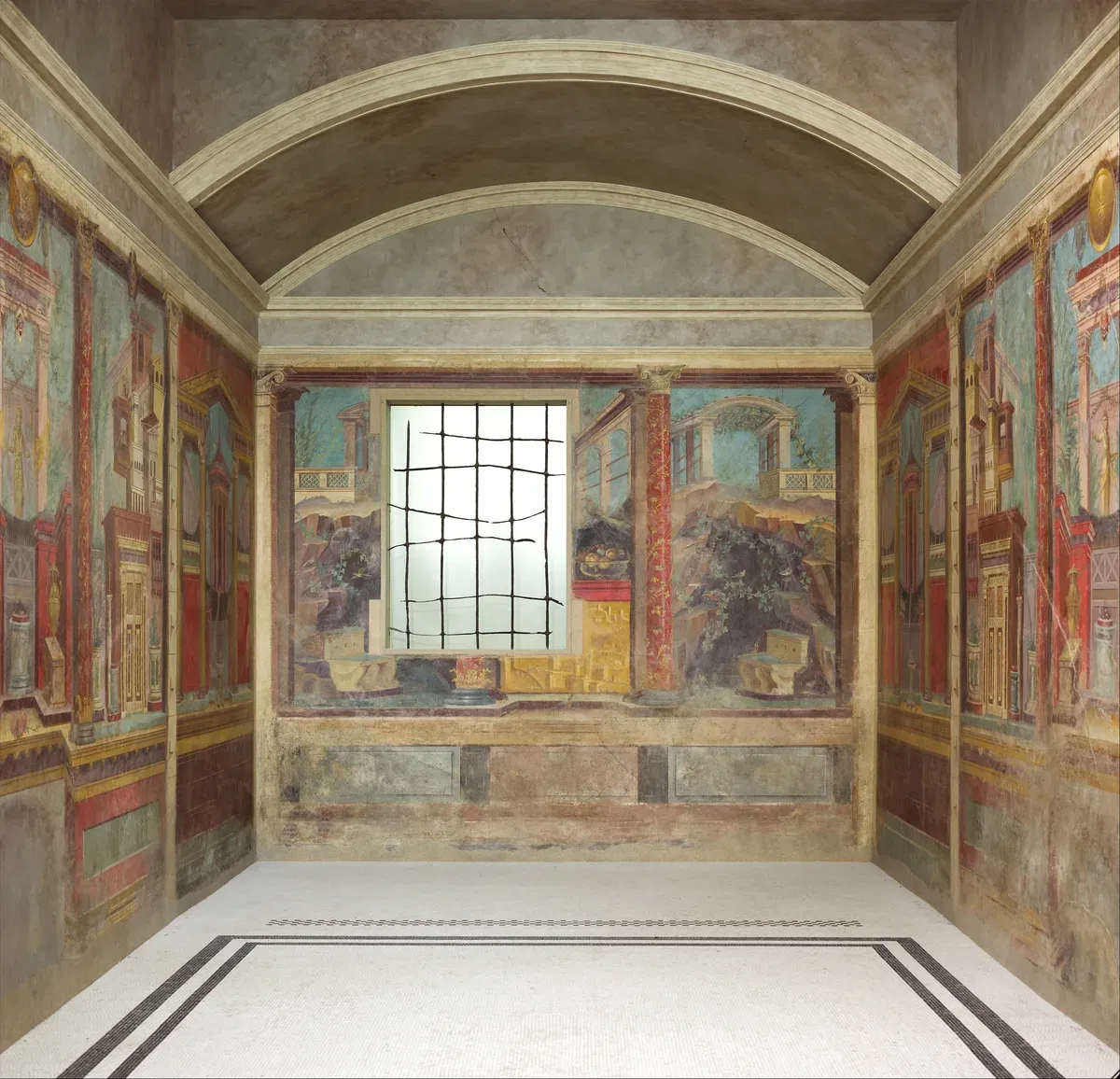 A small Roman bedroom painted on every wall with columns, city views, garden scenes and deep red panels
