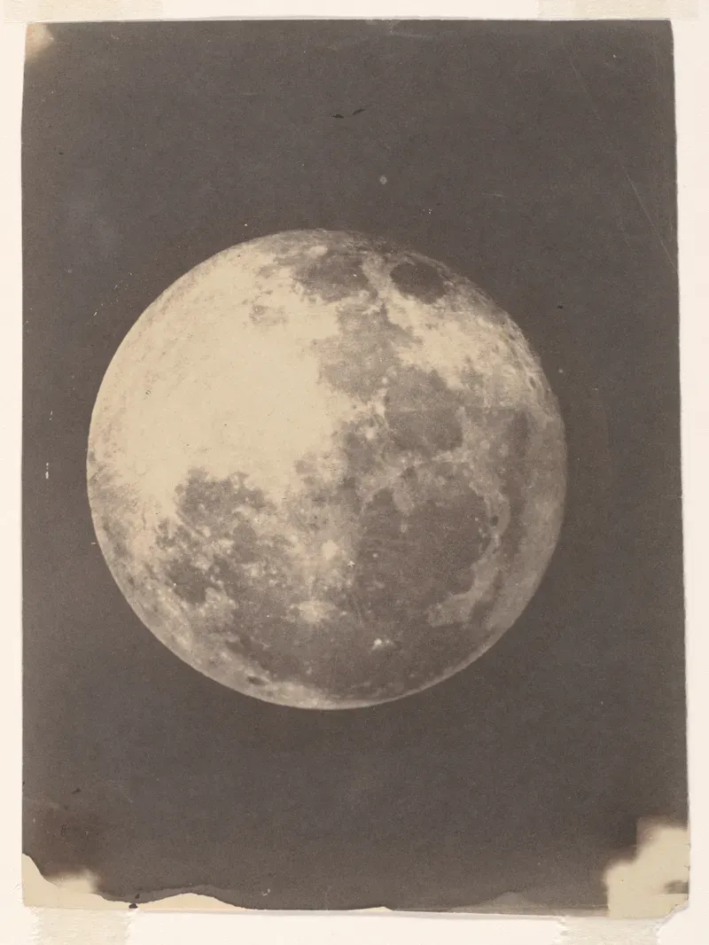Early photograph of the full moon, a pale disk on a dark background