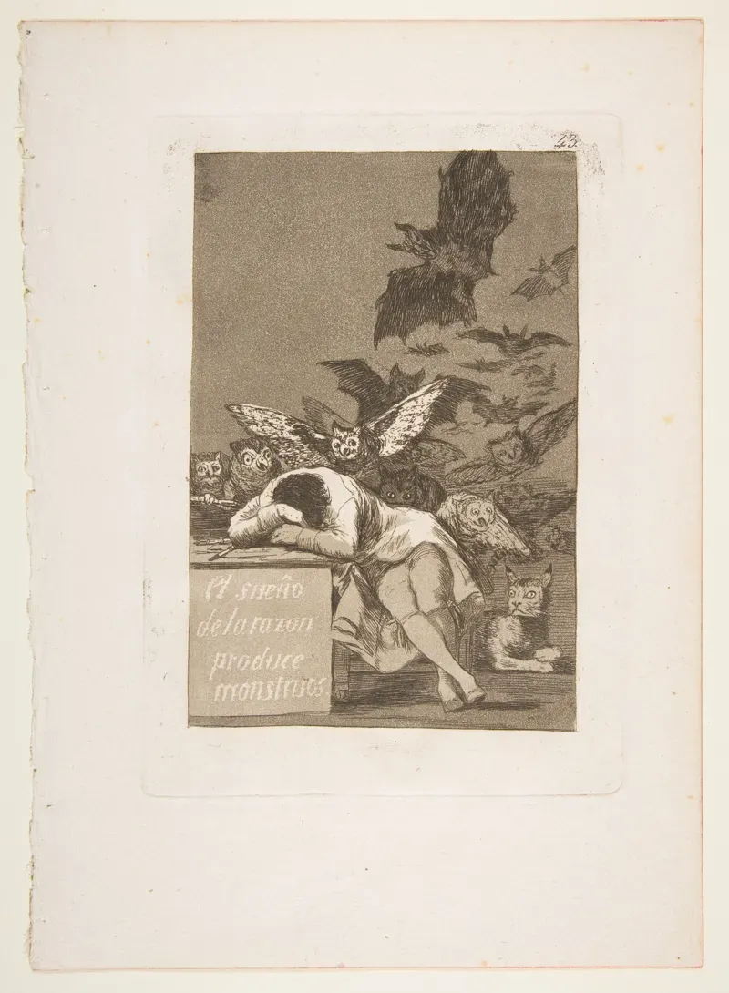 Goya etching of a man asleep at a desk while owls, bats and a lynx crowd out of the darkness behind him