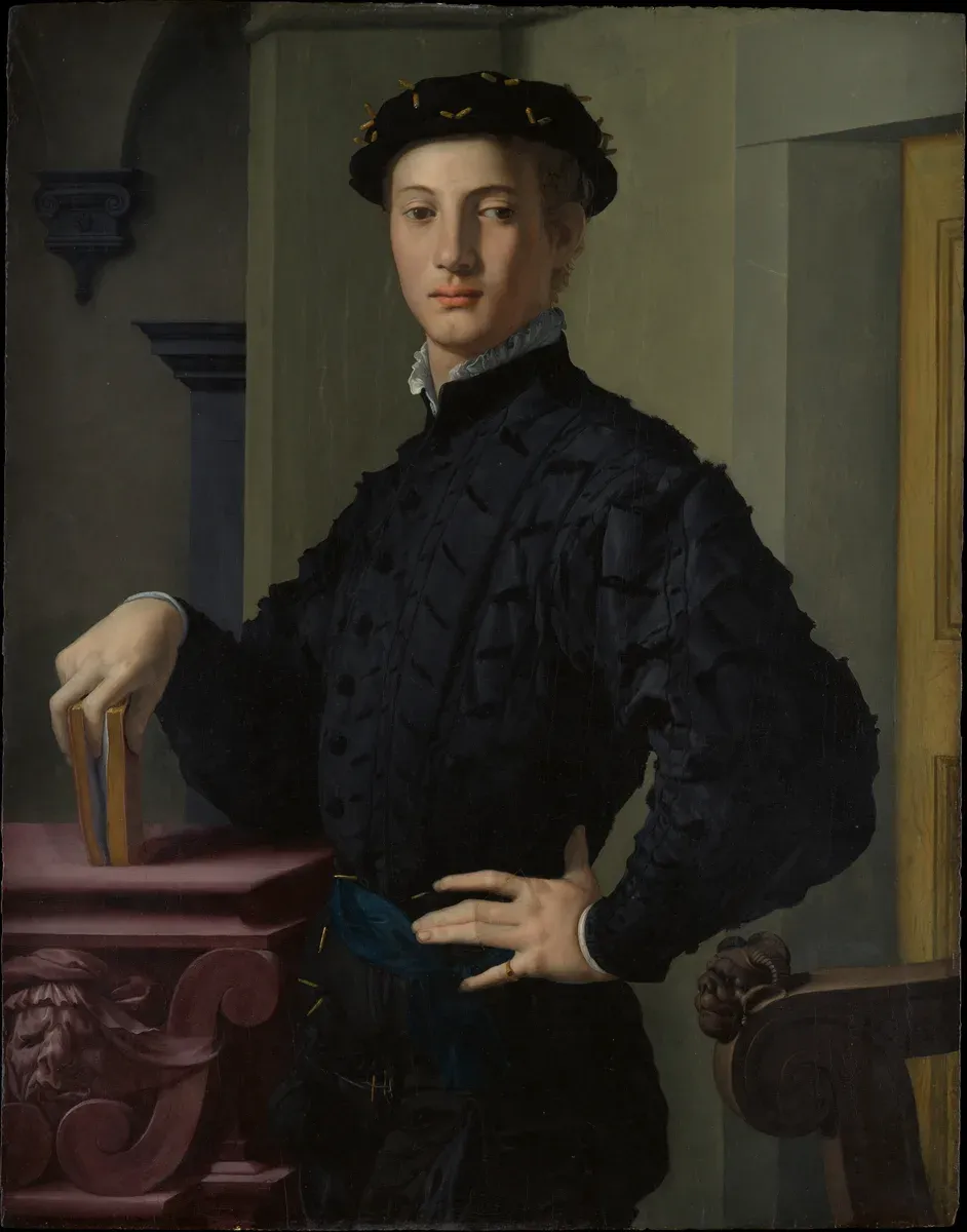 Portrait of an elegant young man in black with a book in his hand