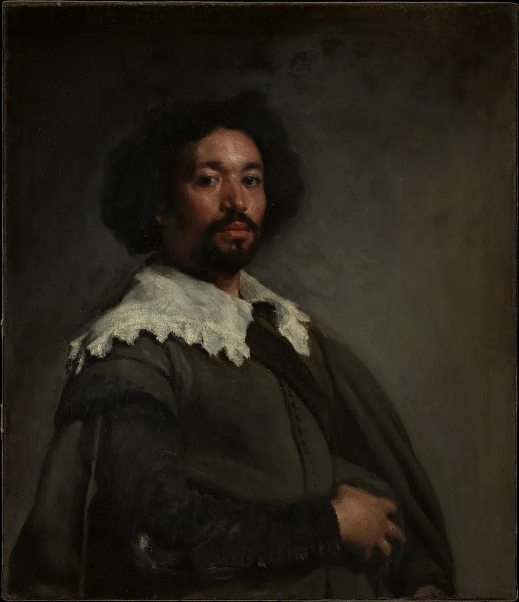 Portrait of a man with dark curly hair and a white lace collar looking straight at the viewer