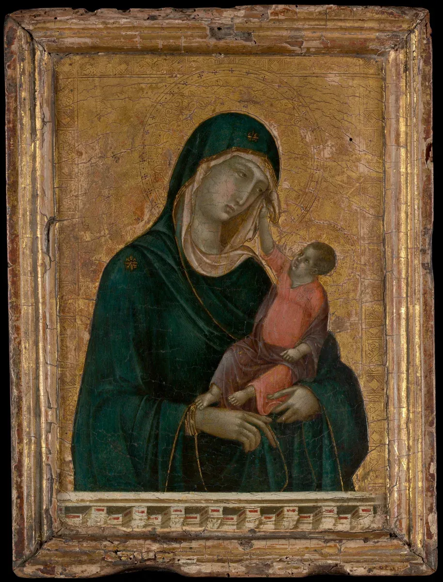 Small gold panel of the Virgin holding the Christ Child, who reaches up to touch her veil, behind a painted parapet