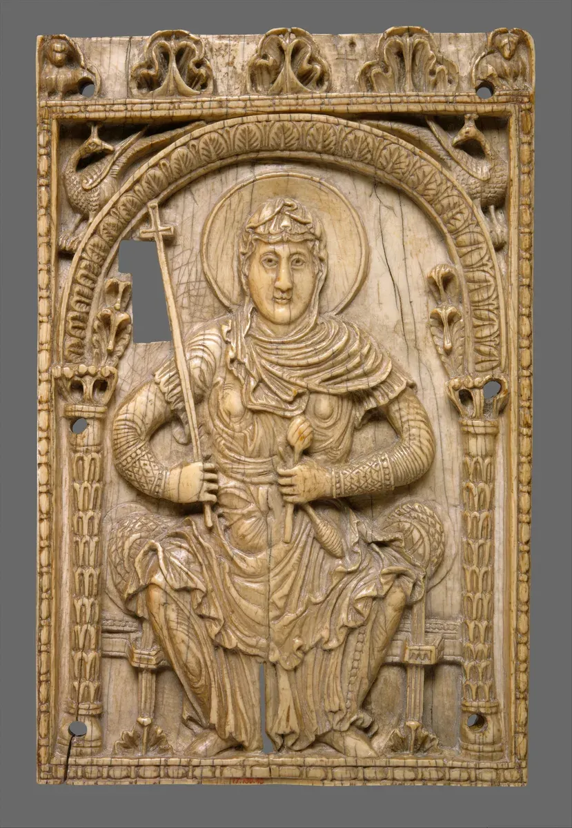 Carved ivory plaque of a crowned woman standing with a staff and banner under an arch