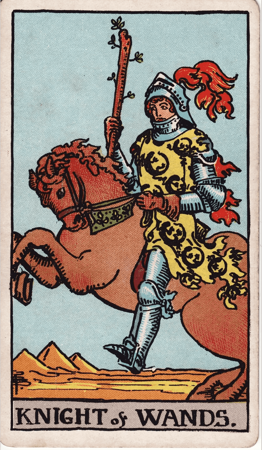 The Knight of Wands from the 1909 Rider-Waite-Smith deck: a knight in armor and a yellow tunic patterned with salamanders rides a rearing horse across a desert past pyramid-shaped mounds, holding a short wand