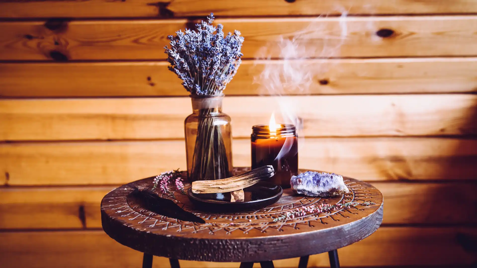 A simple deity altar on a small shelf with candle, offering bowl, and deity image