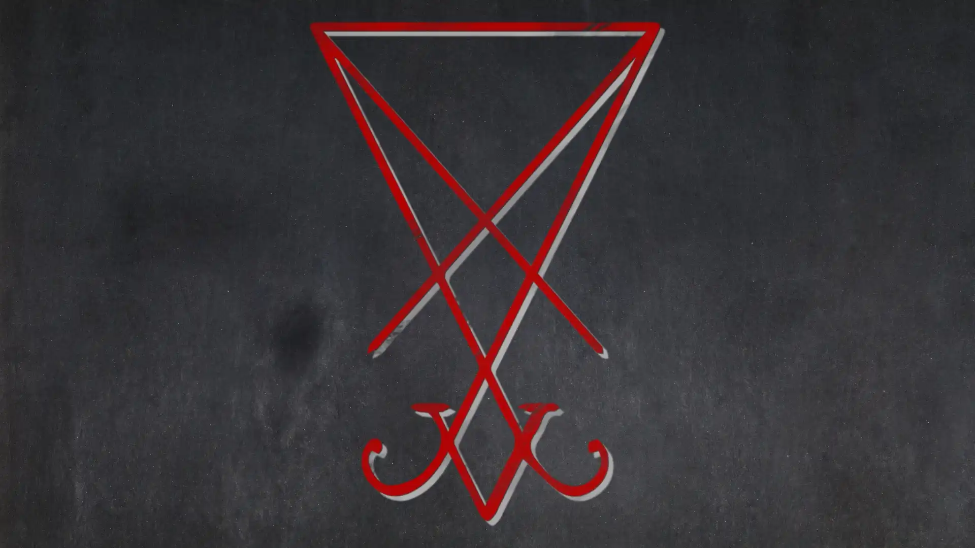 A modern Lucifer altar with candles, books, and star symbols